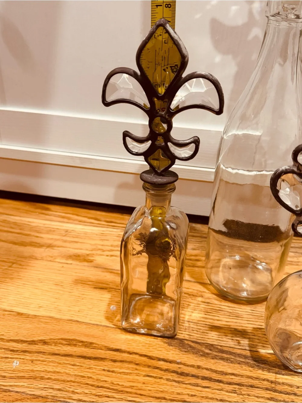 Vintage Decorative Glass Bottle Trio with Fleur & Crown Stoppers - Clear